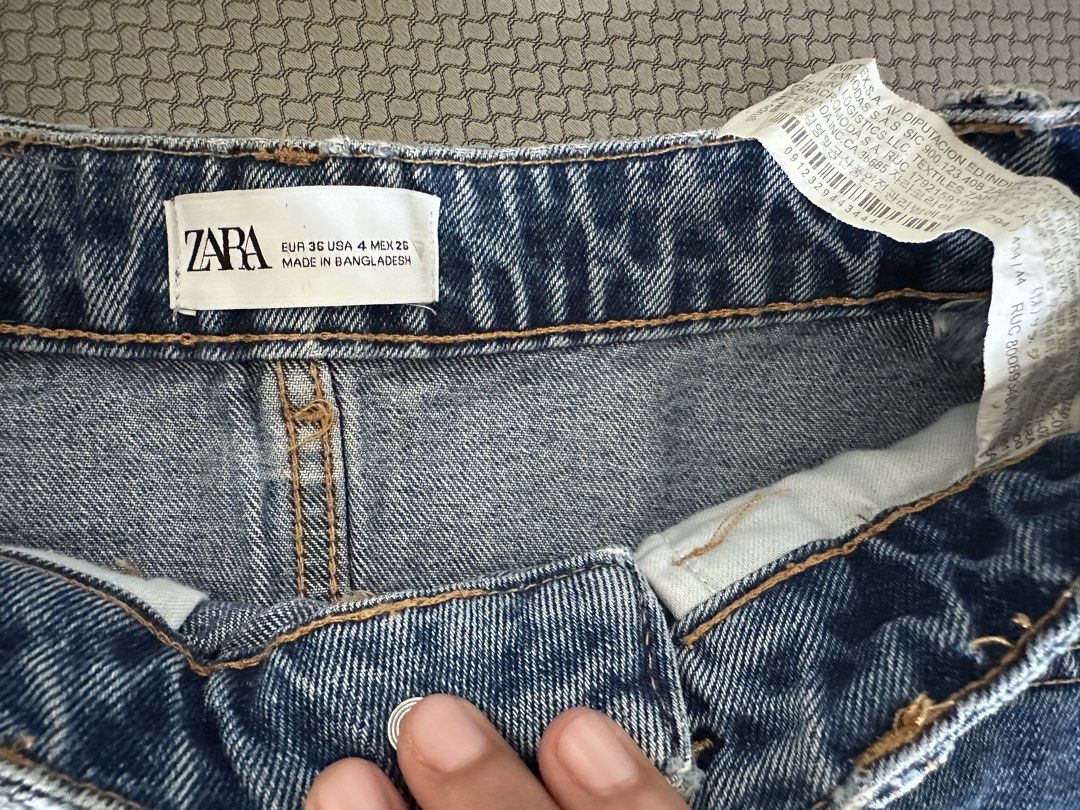 Zara Denim Shorts (Category: Shorts) located in Iloilo. Submitted by letstradee (Listing ID 1430978243, Image 3). Description: Zara denim shorts in a classic blue wash. Features a high-waisted design with front and back pockets. The shorts have a button and zipper closure. The label indicates a size EUR 36, US 4, MEX 26..