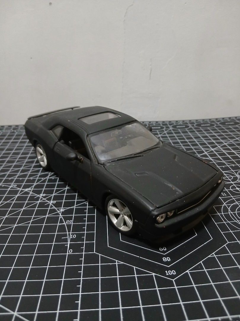 - Maisto 1/24 scale Dodge Challenger Diecast (Category: Vehicle & Diecast Models) located in Tanauan. Submitted by jeuskingz (Listing ID 1431171147, Image 2). Description: - Maisto 1/24 scale Dodge Challenger diecast. - Sleek black color. - Detailed interior and engine. - Paint Chips - Opening doors and hood. - Ideal for collectors and car enthusiasts. - Side Mirror Left Side Missing.