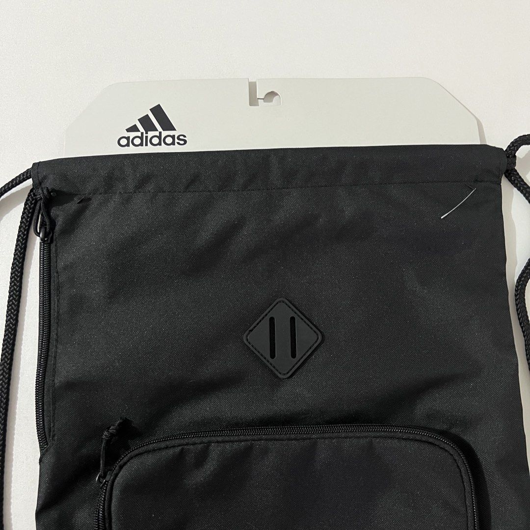 Adidas Classic 3-Stripes Sackpack Drawstring Bag (Category: Backpacks) located in Quezon City. Submitted by jhb218 (Listing ID 1431068550, Image 3). Description: - Dimensions: 36.75 cm x 5 cm x 47 cm - 100% recycled polyester - Easy cinch opening with durable cording - Secure zip pocket -Product color: Black.