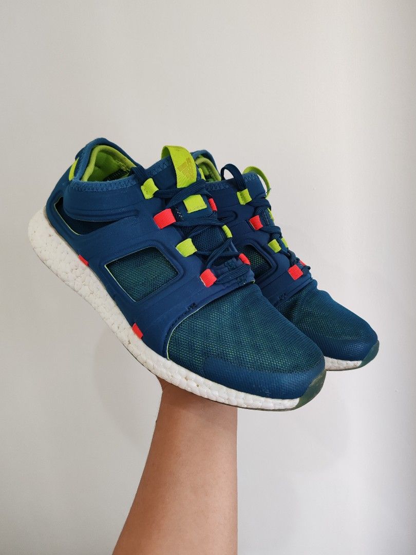 Adidas Pureboost Go Navy Blue Sneakers (Category: Sneakers) located in Baguio. Submitted by pop_up_items (Listing ID 1431024911, Image 3). Description: Adidas Pureboost Go sneakers in navy blue with white soles. Features a mesh upper and a unique lacing system with red and yellow accents. The shoes have a green insole and the Adidas logo is visible on the heel. The size tag indicates a US size 7.5 and UK size 7..