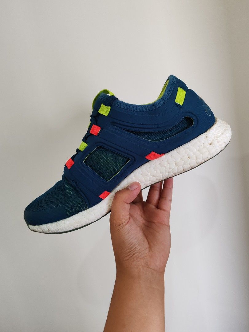 Adidas Pureboost Go Navy Blue Sneakers (Category: Sneakers) located in Baguio. Submitted by pop_up_items (Listing ID 1431024911, Image 2). Description: Adidas Pureboost Go sneakers in navy blue with white soles. Features a mesh upper and a unique lacing system with red and yellow accents. The shoes have a green insole and the Adidas logo is visible on the heel. The size tag indicates a US size 7.5 and UK size 7..
