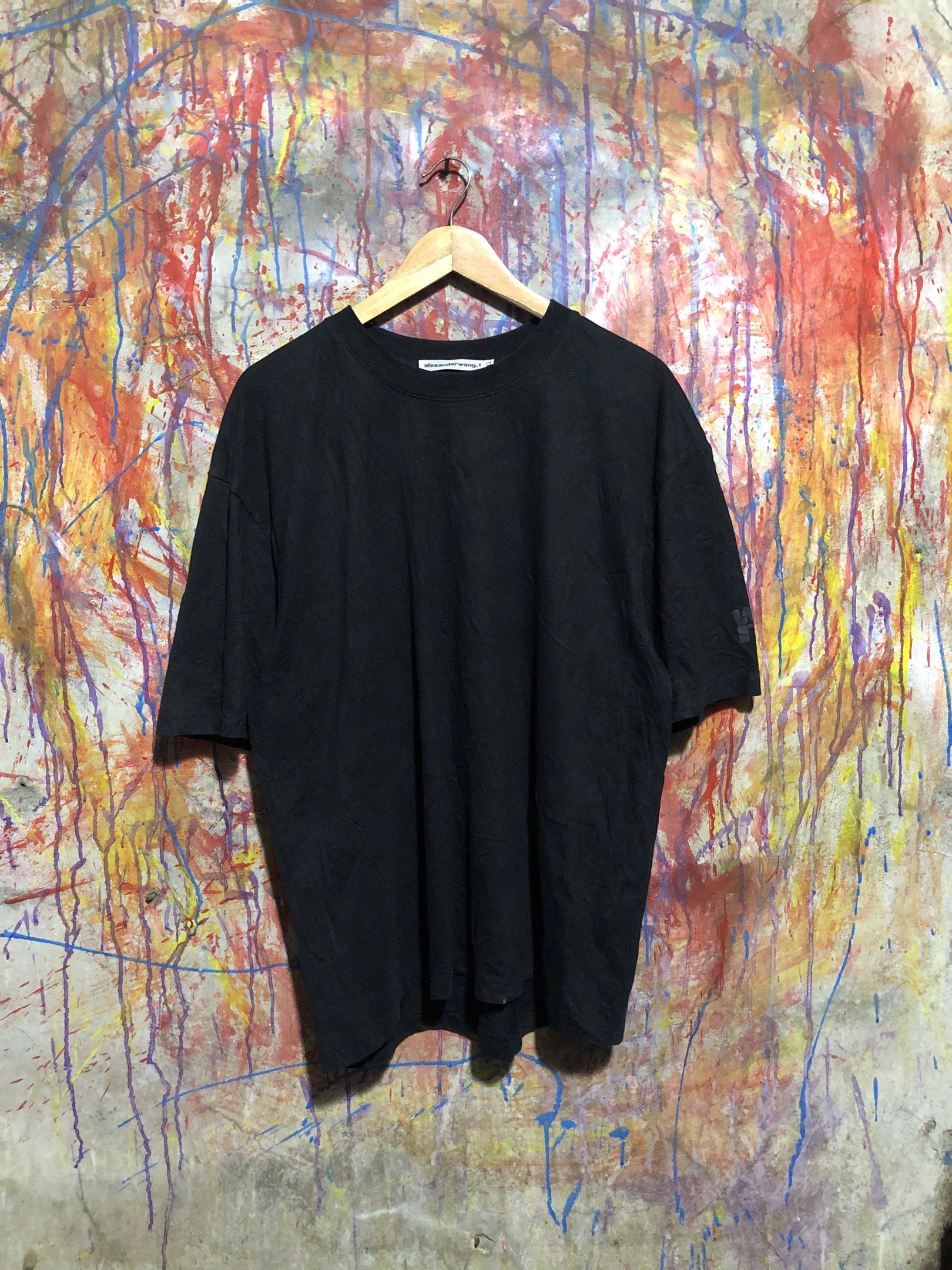 Alexander Wang Black Tshirt (Category: Luxury Apparel) located in Quezon City. Submitted by unholy_finds (Listing ID 1431049661, Image 1). Description: - Black Alexander Wang T-shirt - Size: XL - Features brand logo on sleeve and neckline - Material: 100% Cotton - Relaxed fit - Washing instructions on tag.