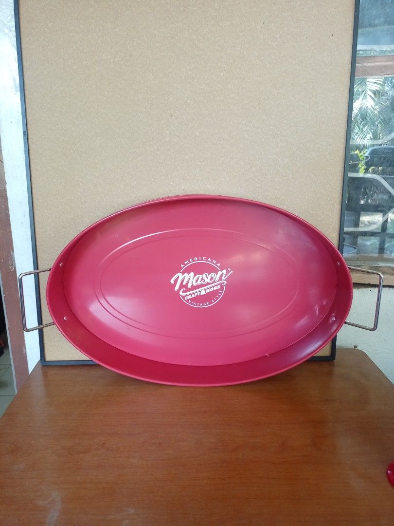 Americana Mason Oval Serving Tray (Category: Other Kitchenware & Tableware) located in Baguio. Submitted by klutter.curio (Listing ID 1431074383, Image 2). Description: Oval serving tray features the Americana Mason logo. It has a vibrant red color and includes handles for easy carrying. The tray is designed with a slightly raised edge to prevent items from sliding off. It's a stylish piece for serving food or displaying items..