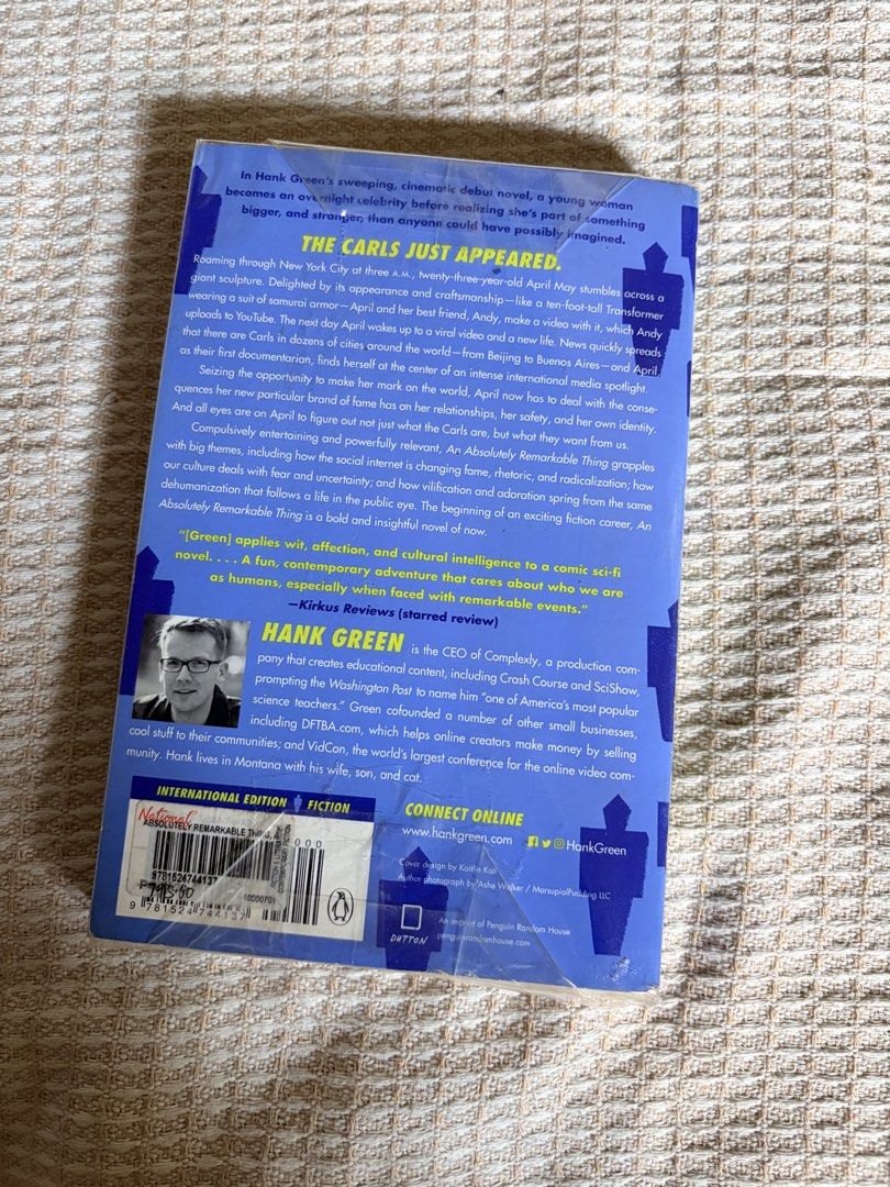 An Absolutely Remarkable Thing by Hank Green (Category: Storybooks) located in Urdaneta. Submitted by sunflowersyd (Listing ID 1431001469, Image 2). Description: - 'An Absolutely Remarkable Thing' by Hank Green - Features a striking blue and yellow cover design - Includes author information and book summary on the back cover For shipping (fees to be covered by buyer, estimated 150php sf via jnt) DM for more photos. Book is already plastic wrapped