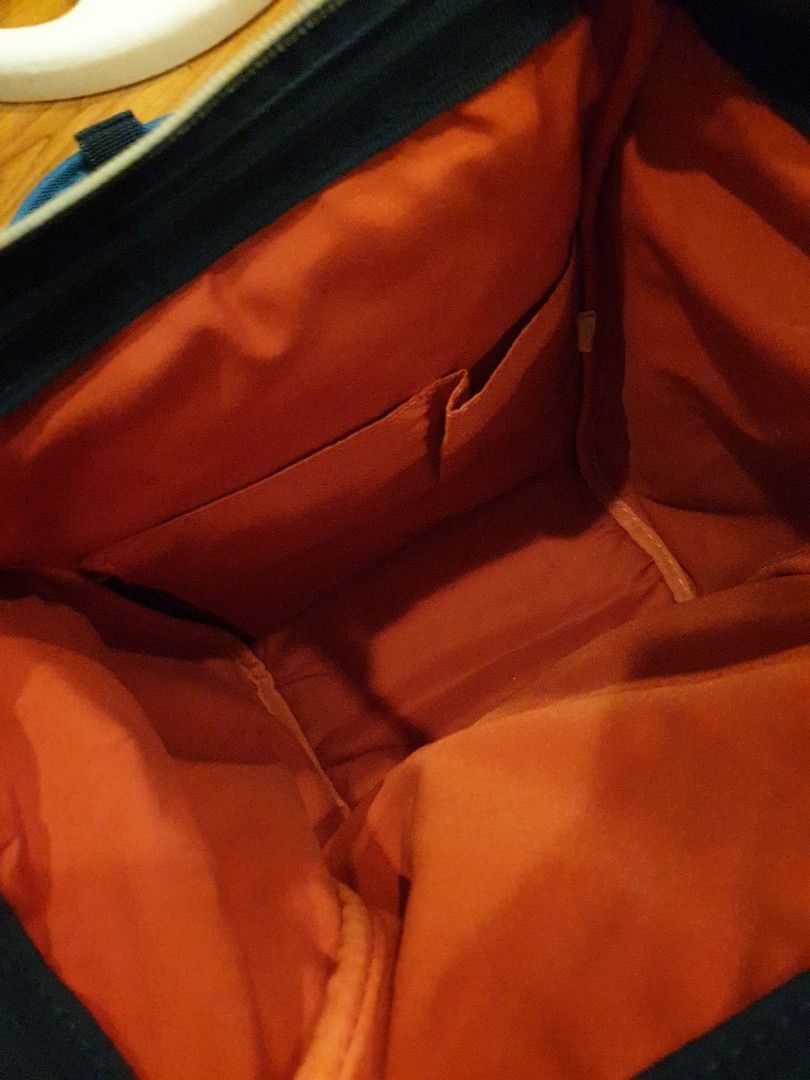 Anello Backpack - Blue (Category: Backpacks) located in Quezon City. Submitted by aredattic (Listing ID 1431067745, Image 2). Description: Blue Anello backpack with a spacious orange interior. Features a top handle and adjustable shoulder straps. Includes a front zipper pocket, 2 side pockets, and a main compartment zipper. The backpack has a small brand tag on the front. flaws: little stains and softened bag structure RFS: decluttering.