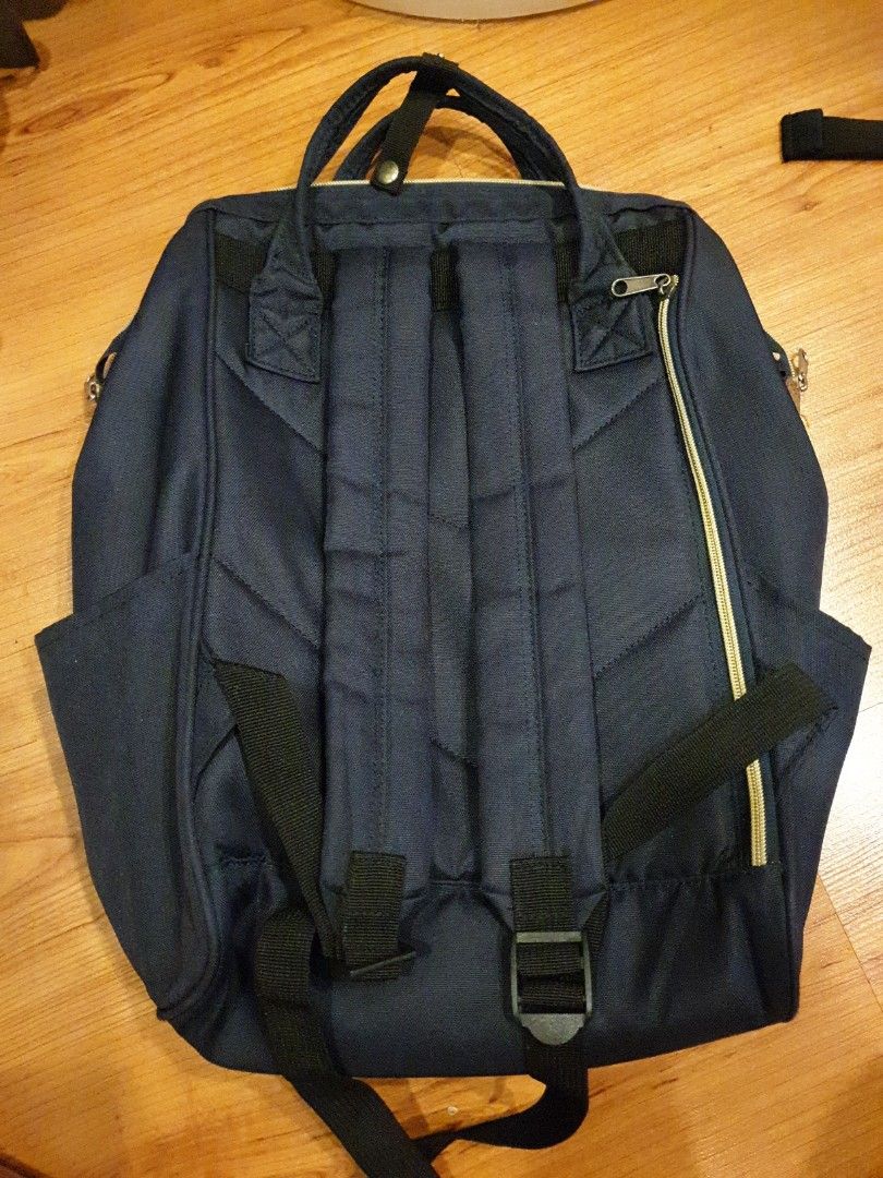 Anello Backpack - Navy Blue (Category: Backpacks) located in Quezon City. Submitted by aredattic (Listing ID 1431067725, Image 2). Description: Navy blue Anello backpack. The interior is teal. Features a top handle and adjustable shoulder straps. Includes a front zipper pocket, 2 side pockets, and a main compartment zipper. The backpack has a small brand tag on the front. flaws: softened bag structure RFS: decluttering.