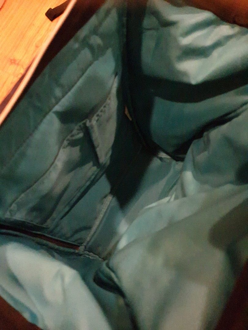Anello Backpack - Navy Blue (Category: Backpacks) located in Quezon City. Submitted by aredattic (Listing ID 1431067725, Image 3). Description: Navy blue Anello backpack. The interior is teal. Features a top handle and adjustable shoulder straps. Includes a front zipper pocket, 2 side pockets, and a main compartment zipper. The backpack has a small brand tag on the front. flaws: softened bag structure RFS: decluttering.