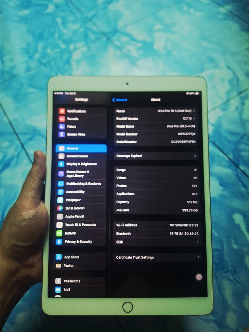 Apple iPad Pro 10.5 inch (Category: iPad) located in Quezon City. Submitted by minimalist.man (Listing ID 1431104769, Image 1). Description: Apple iPad Pro 10.5 inch with 512GB storage. The device is silver. The screen displays the settings menu. There are dents on the two corners of the device. The back of the iPad shows the Apple logo. The device has a front-facing camera and a home button..