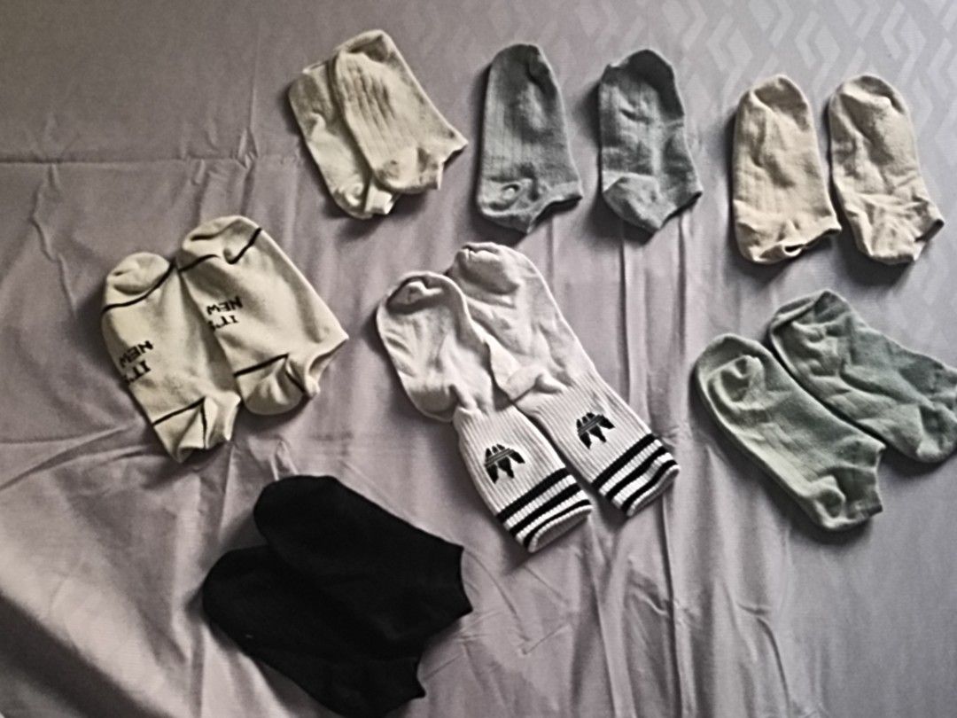 Assorted Socks Bundle (Category: Socks) located in Kuala Lumpur. Submitted by storeyblock (Listing ID 1431167347, Image 1). Description: Bundle of assorted socks in various colors and styles. Includes pairs with Nike and Adidas logos, as well as plain socks in black, grey, and beige. Perfect for everyday wear. Sizes appear to be standard, suitable for adults..