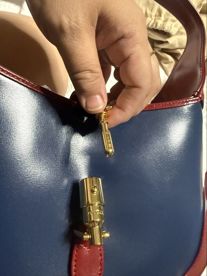Marked Down! Authentic Gucci Jackie 1961 Shoulder Bag Bicolor (Category: Luxury Bags & Wallets) located in Quezon City. Submitted by mlam71 (Listing ID 1428553255, Image 2). Description: Guaranteed Authentic Used only once, on hand Gucci Jackie 1961 Bicolor (navy and red) All calf leather, gold hardware Shoulder/handbag Details: Blue calfskin leather exterior with red calfskin leather trim, canvas lining and gold-tone hardware Piston lock closure