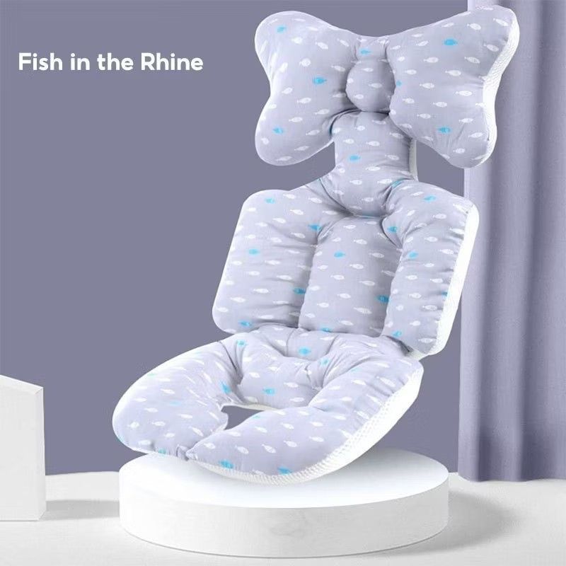 Baby seat cushion (Category: Strollers) located in Makati City. Submitted by littonton (Listing ID 1431001559, Image 2). Description: Baby seat features a unique design with a bow-shaped headrest and a fish pattern. The seat is designed to support the baby's head and body. The color scheme is a soft gray with white and blue accents. It is designed to be placed on a chair..