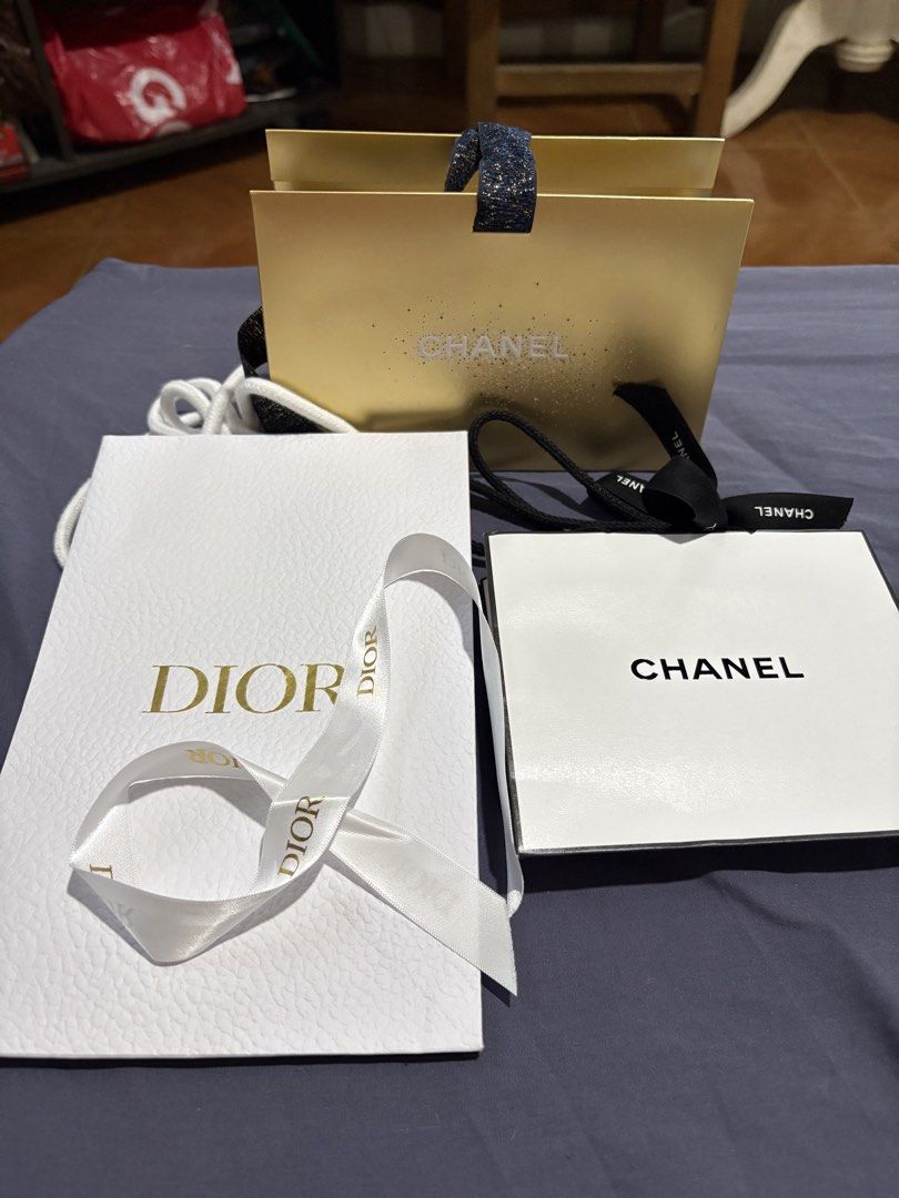 Chanel and Dior Gift Packaging (Category: Luxury Bags & Wallets) located in Quezon City. Submitted by brandedthingsforless (Listing ID 1431081774, Image 1). Description: Includes a gold Chanel gift bag, a white Chanel box, and a white Dior box. The Chanel bag has a glittery handle. The Dior box has a white ribbon. All items appear to be unused. Perfect for gifting or storing small items..