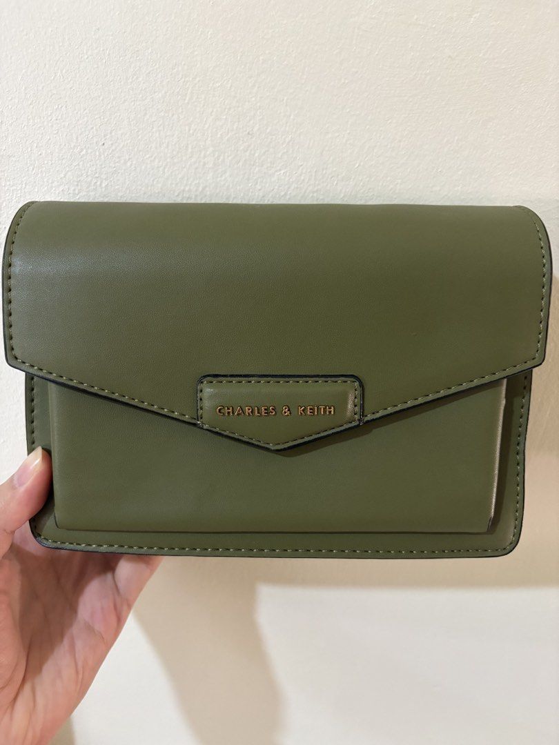Charles & Keith Olive Green Bag (Category: Shoulder Bags) located in Cainta. Submitted by kpc905 (Listing ID 1430996082, Image 1). Description: Original Charles & Keith Never used, only stored in cabinet With tag, straps, and dust bag Has visible leather creases/issues so kindly lower your expectations. Selling it for a low price because of the leather issues.