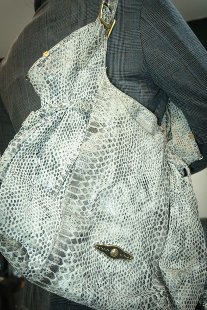 Elliott Lucca Snakeskin Hobo Bag (Category: Shoulder Bags) located in Silang. Submitted by melstore (Listing ID 1431104096, Image 2). Description: PRE LOVED ORIGINAL Elliott Lucca hobo bag features a snakeskin pattern in shades of gray and white. It has a single shoulder strap and a top zipper closure. The interior lining has a floral pattern and includes a zippered pocket. The bag has a gold-tone clasp with the brand name on it..