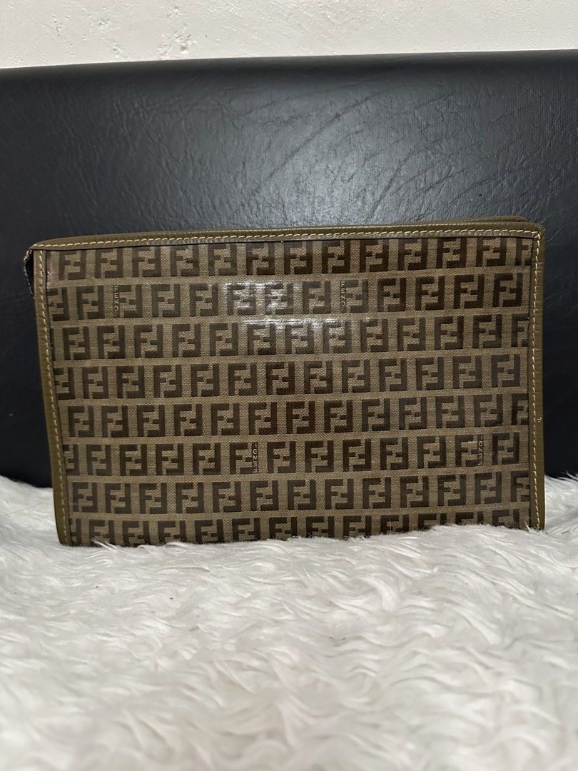 Fendi FF Logo Clutch (Category: Luxury Bags & Wallets) located in Marilao. Submitted by curleylux (Listing ID 1431014325, Image 2). Description: Authentic Fendi clutch featuring the iconic FF logo pattern. The clutch has a zip closure and a spacious interior. The interior is lined with a dark brown material. The zipper pull has the Fendi logo. The clutch is made in Italy..