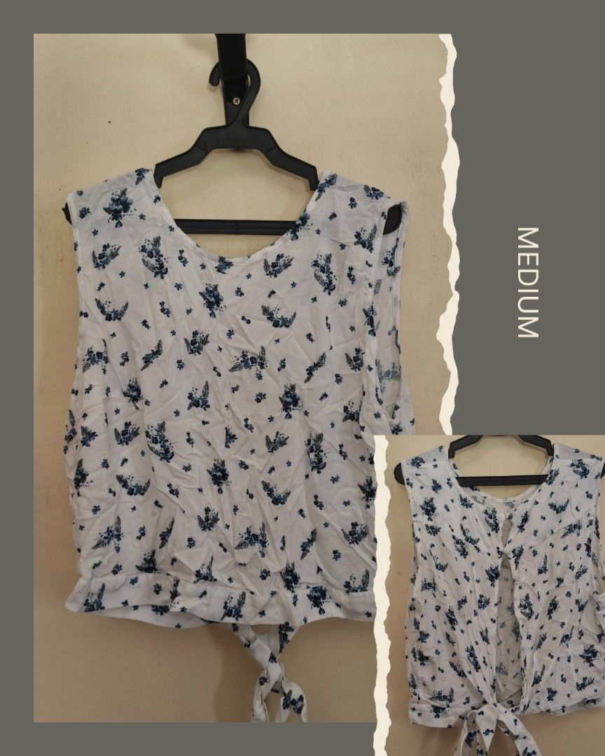 Floral Sleeveless Top - Medium (Category: Sleeveless) located in Loay. Submitted by arakesh21 (Listing ID 1431180912, Image 1). Description: White sleeveless top with a floral pattern. Features a V-neckline and a tie detail at the waist. The top is a medium size. It has a relaxed fit and a simple, yet stylish design..
