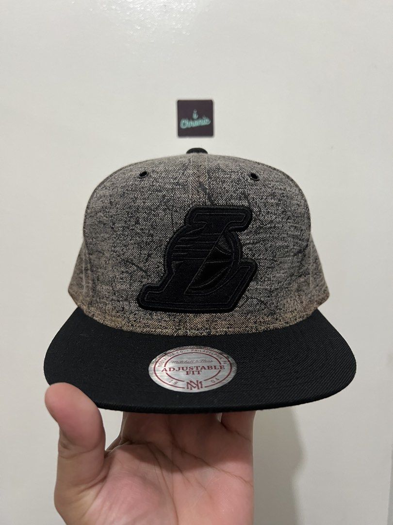 Grey Mitchell and Ness Los Angeles Lakers Snapback (Category: Caps & Hats) located in Pasig City. Submitted by ichronicshop (Listing ID 1431158576, Image 1). Description: Mitchell and Ness Los Angeles Lakers Snapback Grey issue is yellowing near threads. other than that sobrang ganda at collectible nito for Lakers collectors ₱2,000 0NLY ‼️ Condition: Used, but in good condition 📌 Payment: Bank transfer, GCash, Cash. 📌 Rosario , Pasig pick-up 🙂