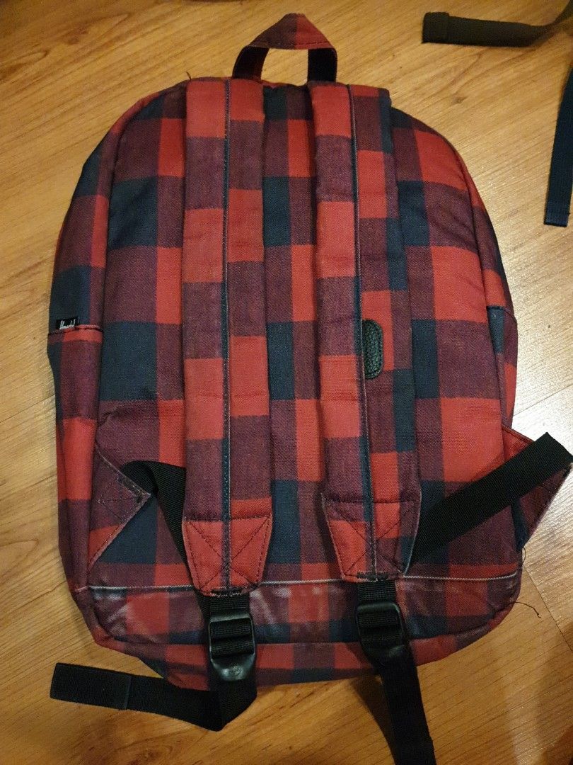 Herschel Backpack Red Plaid (Category: Backpacks) located in Quezon City. Submitted by aredattic (Listing ID 1431067762, Image 2). Description: Herschel backpack in a red and black plaid pattern. Features a black front pocket with a Herschel label and laptop compartment. Includes adjustable shoulder straps. flaw: top pocket has a hole RFS: decluttering.