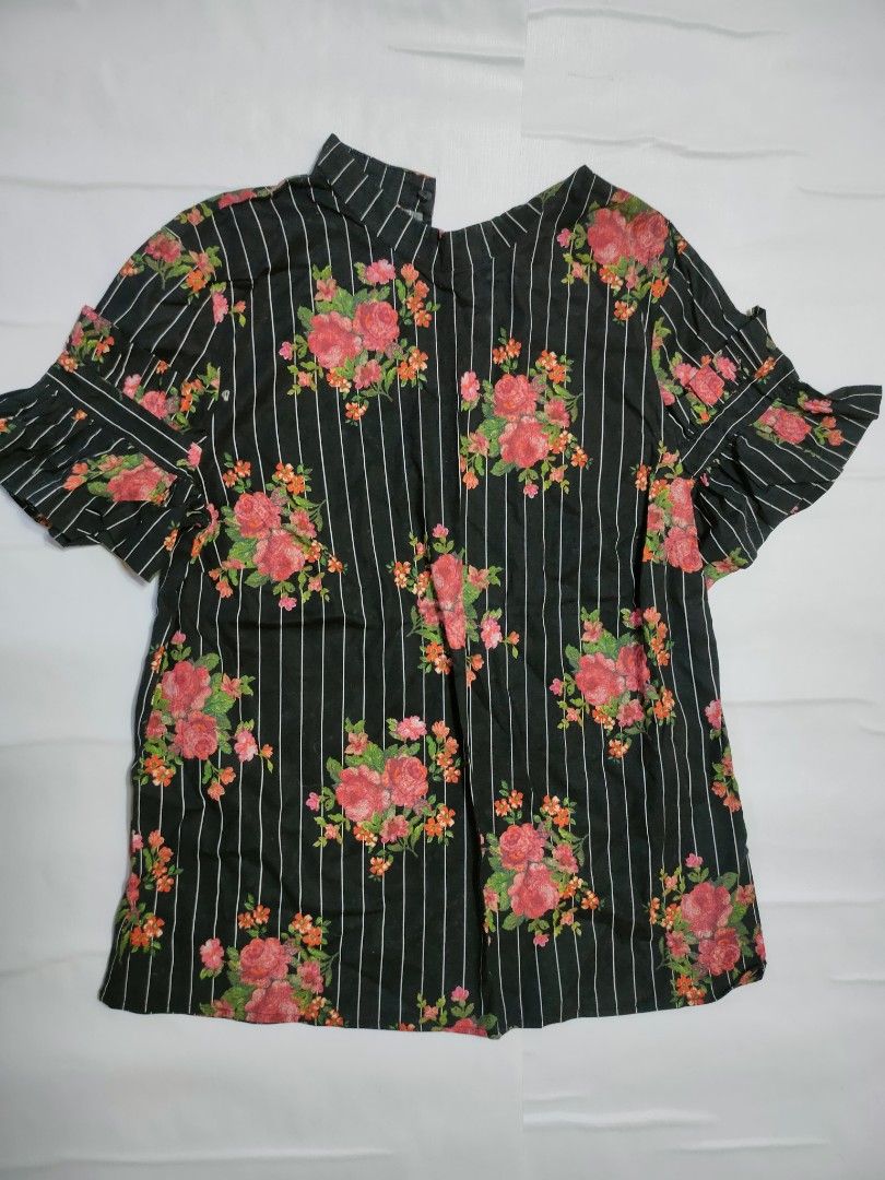 H&M Floral Striped Blouse Black (Category: Blouses) located in Marikina City. Submitted by styledandsassified (Listing ID 1431141378, Image 1). Description: H&M blouse features a black and white striped pattern with a floral design. It has short sleeves with ruffle details and a high neckline. The blouse has a split at the back. The tag indicates it is a size EUR 34..