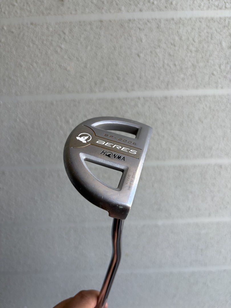 Honma Beres Putter (Category: Golf) located in Santa Rosa. Submitted by rumborro (Listing ID 1430990876, Image 1). Description: - Honma Beres putter - Sleek silver finish - Black grip with white accents and Honma logo - Includes matching head cover - Unique curved shaft design - Honma Beres logo and model number on the head.
