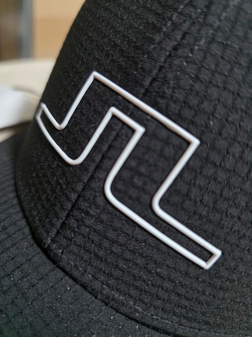 j.lindeberg Black Cap (Category: Caps & Hats) located in Quezon City. Submitted by yGGGG (Listing ID 1431023131, Image 2). Description: Black cap from J.Lindeberg. Features the brand logo on the front and the brand name on the side. Includes an adjustable strap at the back. Comes with a tag attached. Brandnew.