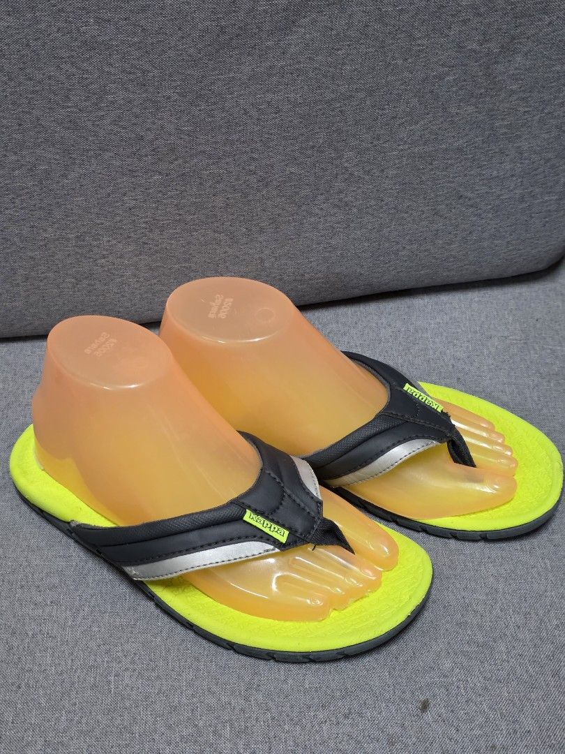 Kappa Flip-flops - Yellow and Black (Category: Slippers and slides) located in General Trias. Submitted by roselle2230 (Listing ID 1430996035, Image 3). Description: Kappa flip-flops with a vibrant yellow sole and black straps. Features a silver accent on the straps and the Kappa logo. The sole is gray with a textured design for grip. The flip-flops appear to be unworn..