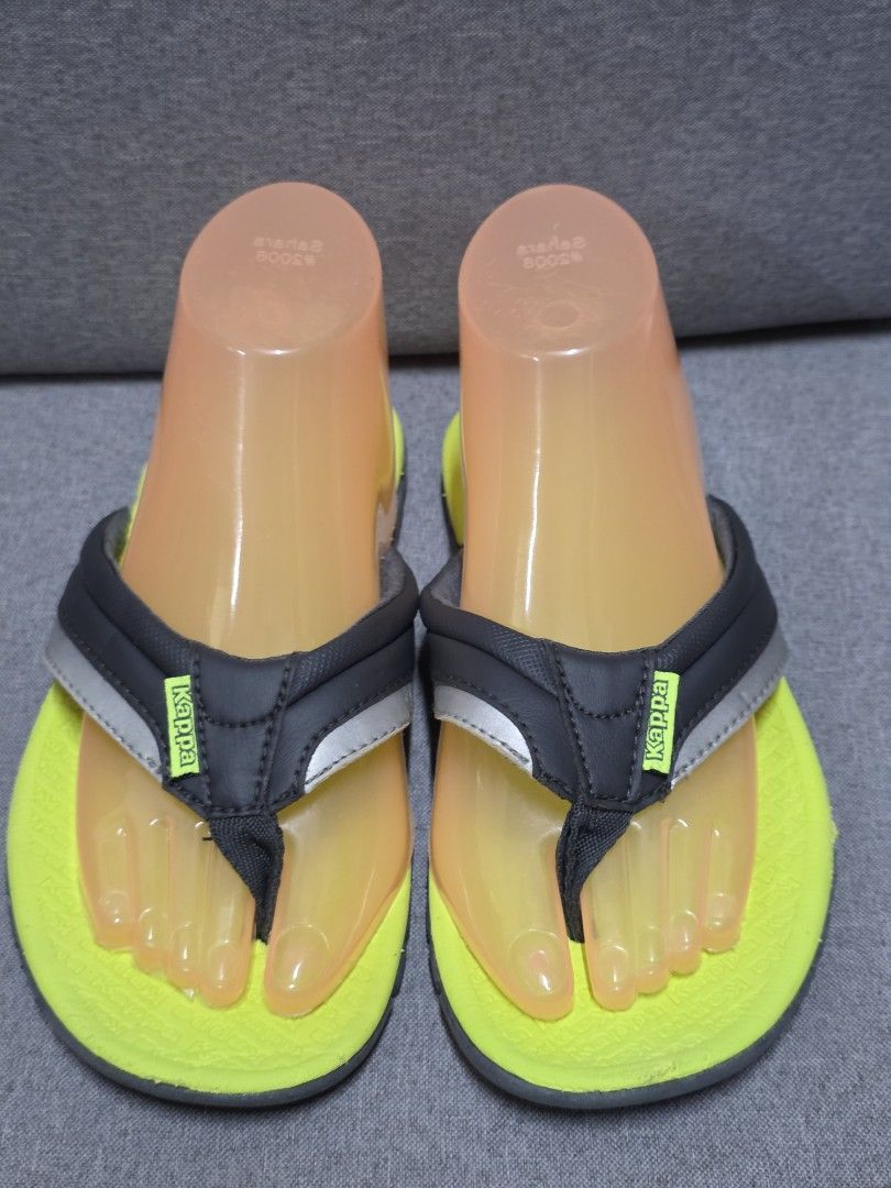 Kappa Flip-flops - Yellow and Black (Category: Slippers and slides) located in General Trias. Submitted by roselle2230 (Listing ID 1430996035, Image 1). Description: Kappa flip-flops with a vibrant yellow sole and black straps. Features a silver accent on the straps and the Kappa logo. The sole is gray with a textured design for grip. The flip-flops appear to be unworn..