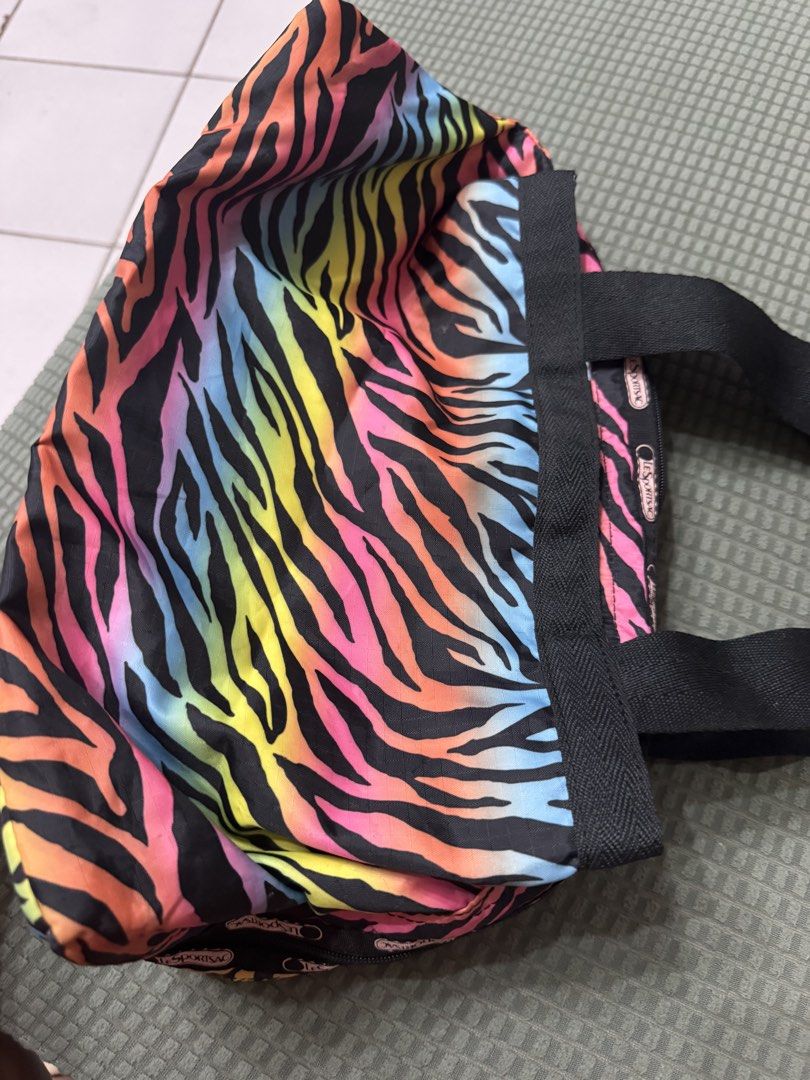 LeSportsac Rainbow Zebra Messenger Bag (Category: Tote Bags) located in Manila. Submitted by plusCize (Listing ID 1431121726, Image 3). Description: LeSportsac Rainbow Zebra Messenger Bag, a vintage piece featuring a colorful rainbow zebra exterior. .
