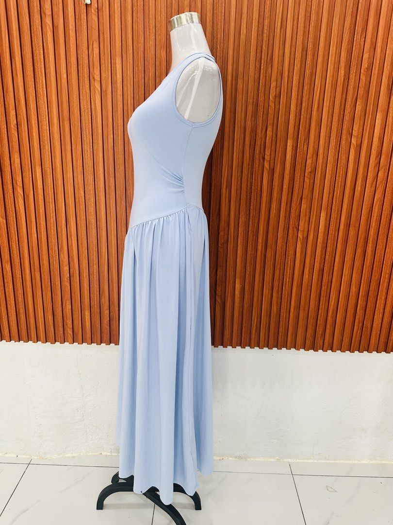 Light Blue Sleeveless Maxi Dress (Category: Dresses) located in Manila. Submitted by cherish_24 (Listing ID 1431020727, Image 2). Description: Elegant light blue maxi dress. Features a sleeveless design with a fitted bodice and a flowing skirt. The dress has a unique diagonal seam detail at the waist, adding a touch of sophistication. Perfect for special occasions or a stylish everyday look..