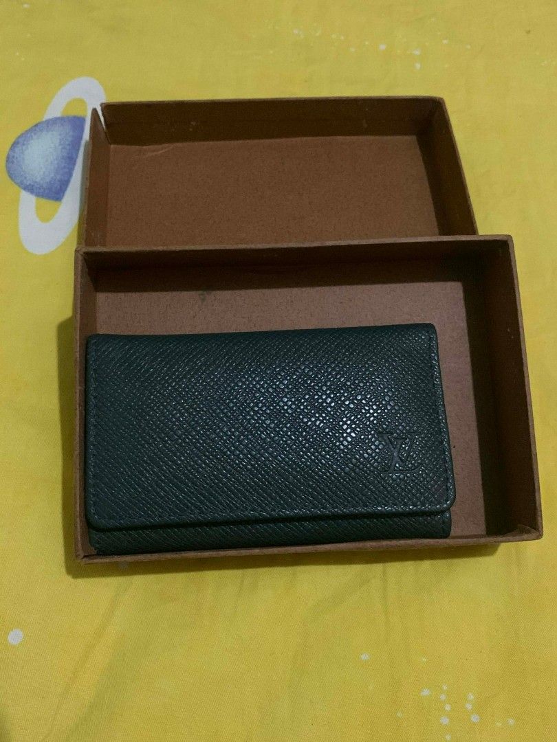 Louis Vuitton Key Holder (Category: Luxury Bags & Wallets) located in Manila. Submitted by yenglaloves04 (Listing ID 1431084509, Image 2). Description: - Authentic Louis Vuitton key holder - Dark green exterior with LV logo - Multiple key hooks - Secure snap closure - Comes with original box - Made in France.