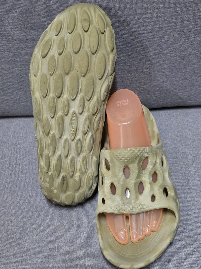 Merrell Hydro Moc Sandals (Category: Slippers & Slides) located in General Trias. Submitted by roselle2230 (Listing ID 1430993632, Image 3). Description: These Merrell Hydro Moc sandals are in a neutral color. They feature a unique design with multiple holes for breathability. The sandals have a contoured footbed for comfort and a durable sole. They are perfect for casual wear or outdoor activities. The sandals are shown with foot-shaped inserts.