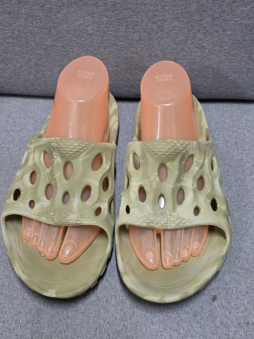 Merrell Hydro Moc Sandals (Category: Slippers & Slides) located in General Trias. Submitted by roselle2230 (Listing ID 1430993632, Image 1). Description: These Merrell Hydro Moc sandals are in a neutral color. They feature a unique design with multiple holes for breathability. The sandals have a contoured footbed for comfort and a durable sole. They are perfect for casual wear or outdoor activities. The sandals are shown with foot-shaped inserts.