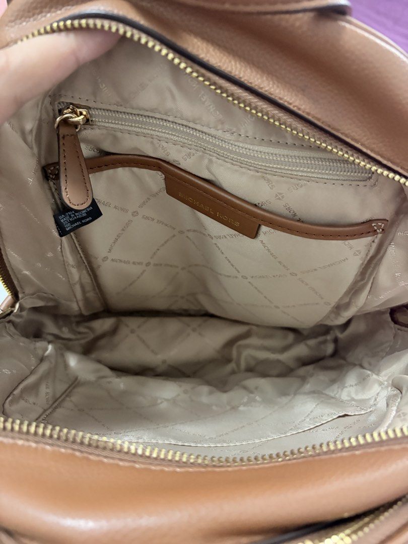 Michael Kors Adina Medium Backpack (Category: Backpacks) located in Manila. Submitted by anggiee.mn (Listing ID 1414717639, Image 3). Description: - Michael Kors backpack - Medium size - Features MK logo print - Brown top handle and trim - Gold-tone zipper - Front pocket - Used only twice - Ideal for daily use - Has its original dust bag Rfs: don’t use often. Only used once. Has small defect on the handle (flaking leather) due to storage. MOD: La
