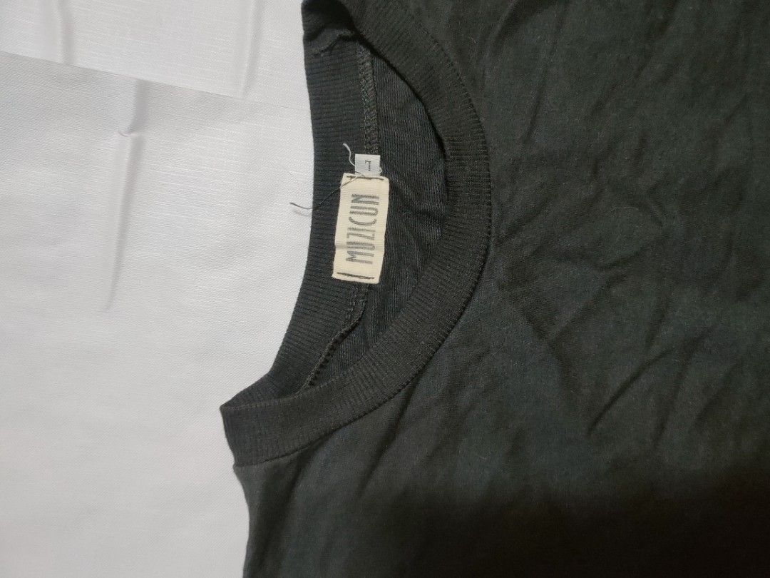 Muzicun Eye Graphic Sweatshirt (Category: Coats, Jackets and Outerwear) located in Marikina City. Submitted by styledandsassified (Listing ID 1431142420, Image 2). Description: Dark grey Muzicun sweatshirt featuring a yellow eye graphic on the front. It has a crew neck and long sleeves. The size tag indicates it is a size L. The Muzicun brand label is visible on the inside of the collar..