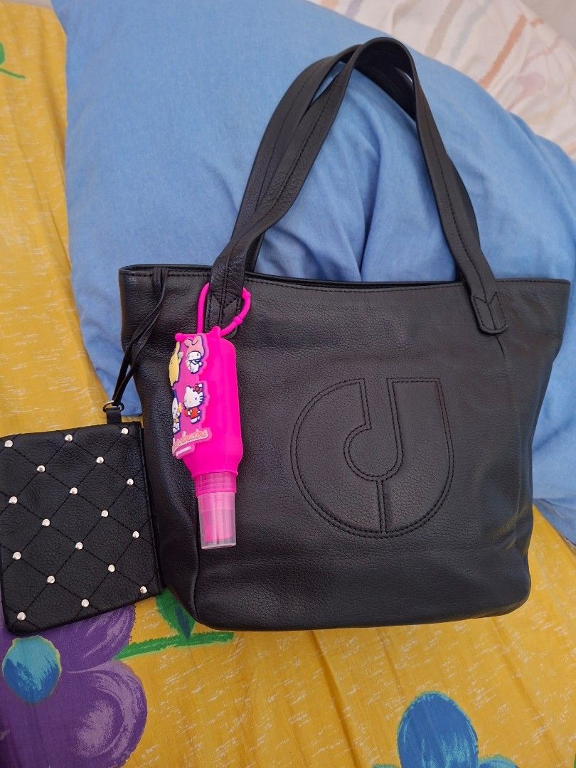 Original Charles Jourdan Paris Bag (Category: Tote Bags) located in Pasig City. Submitted by khaid (Listing ID 1430996040, Image 2). Description: Stylish tote bag with a matching wallet. Features a large embossed logo on the front. Includes a top handle and a detachable wallet. The bag has a spacious interior. The wallet has a zipper closure and studded details. Perfect for everyday use..