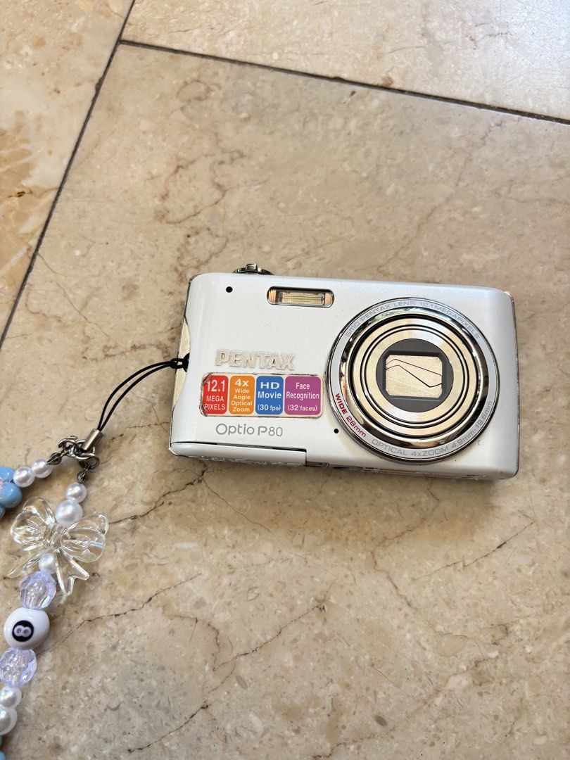 Pentax Optio P80 Digital Camera (Category: Cameras) located in Cavite. Submitted by joe_schmerbatsky (Listing ID 1431053362, Image 1). Description: ⋆˚꩜｡ Pentax Optio P80 Digicam 📷 - 12MP compact digital camera - 4x zoom - Slim and lightweight, perfect for travel and vintage digicam photos - Includes Decorative Beaded Strap - Features: On/Off Button, Mode Dial, Menu Button, Built-in Flash, Small Screen - Tested and working. INCLUSIONS ⋆ ° ꩜.ᐟ ☑️ 