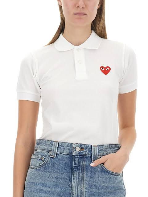 Play Comme des Garcons White Polo Shirt (Category: Tshirts & Polo Shirts ) located in Bacolod City. Submitted by moboandmoga (Listing ID 1431050262, Image 1). Description: Play Comme des Garcons White Polo Shirt Size: Small frame Excellent Condition! (Sizing info) Width: 16 inches Length: 20.5F 22.5B White polo shirt from Play Comme des Garcons. Features the iconic red heart logo on the chest. It has a classic collar and short sleeves. The shirt 