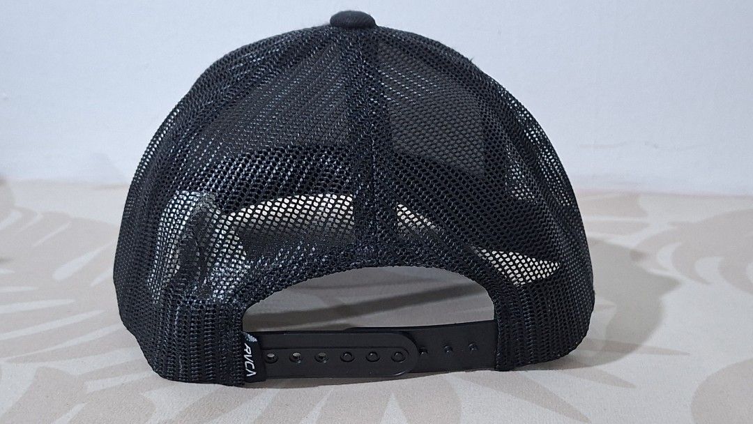 RVCA Boy's Fit Cap (Category: Caps & Hats) located in Imus. Submitted by pick_and_dig (Listing ID 1431173989, Image 3). Description: Black RVCA cap with a mesh back and a curved brim. Features a square RVCA logo patch on the front. The cap is adjustable with a snapback closure. The tag indicates it is made in Bangladesh. Payment via GCash or Maya.