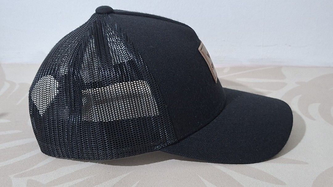 RVCA Boy's Fit Cap (Category: Caps & Hats) located in Imus. Submitted by pick_and_dig (Listing ID 1431173989, Image 2). Description: Black RVCA cap with a mesh back and a curved brim. Features a square RVCA logo patch on the front. The cap is adjustable with a snapback closure. The tag indicates it is made in Bangladesh. Payment via GCash or Maya.