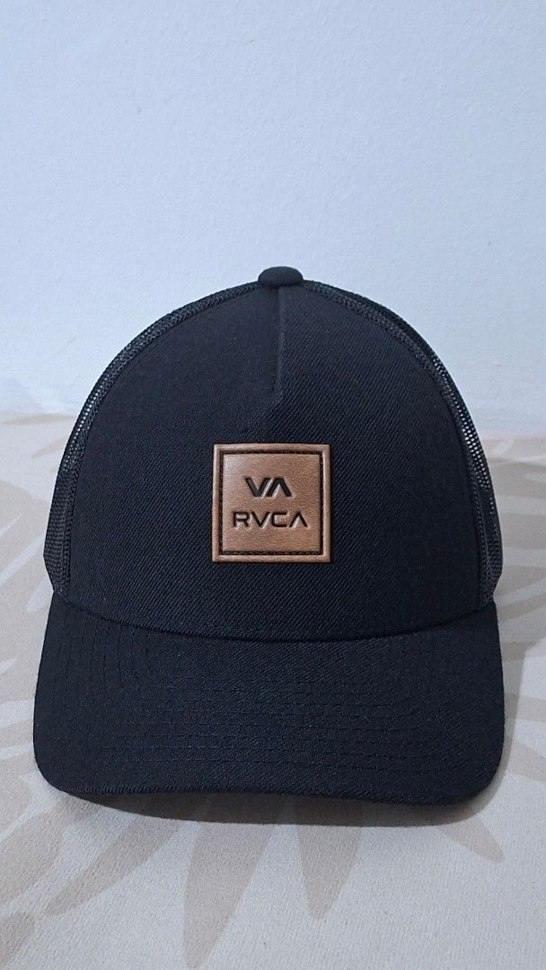 RVCA Boy's Fit Cap (Category: Caps & Hats) located in Imus. Submitted by pick_and_dig (Listing ID 1431173989, Image 1). Description: Black RVCA cap with a mesh back and a curved brim. Features a square RVCA logo patch on the front. The cap is adjustable with a snapback closure. The tag indicates it is made in Bangladesh. Payment via GCash or Maya.