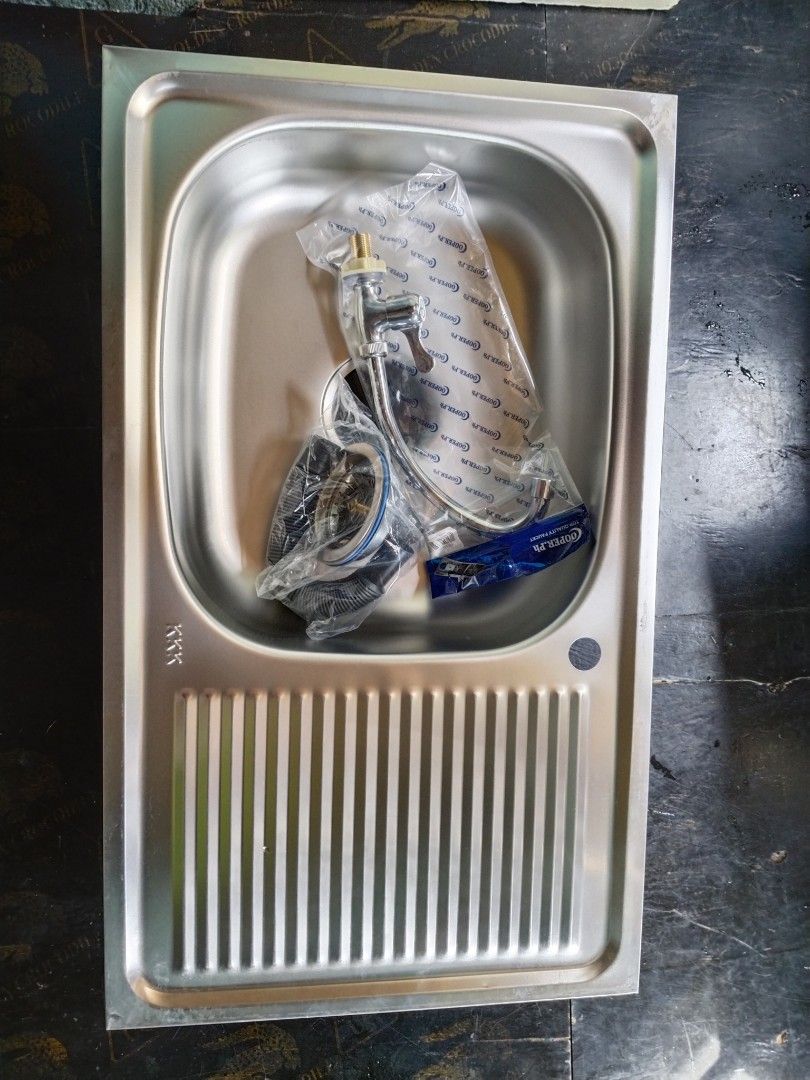 Stainless Steel Kitchen Sink with Drainboard (Category: Bathroom & Kitchen Fixtures) located in Manila. Submitted by muranglababo_ph2026 (Listing ID 1431035110, Image 2). Description: Stainless steel kitchen sink with a drainboard. Includes faucet and other accessories. Features a single basin design. The drainboard has a ribbed design. The sink is rectangular in shape..