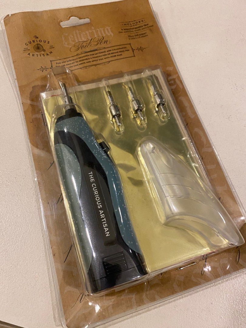 The Curious Artisan Lettering Foil Pen Set (Category: Stationery & School Supplies) located in Davao. Submitted by iam_artisan (Listing ID 1431096371, Image 1). Description: Old stock but brand new. Can be used on any surfaces. Portable and battery operated. Kit comes with foil sheets. .