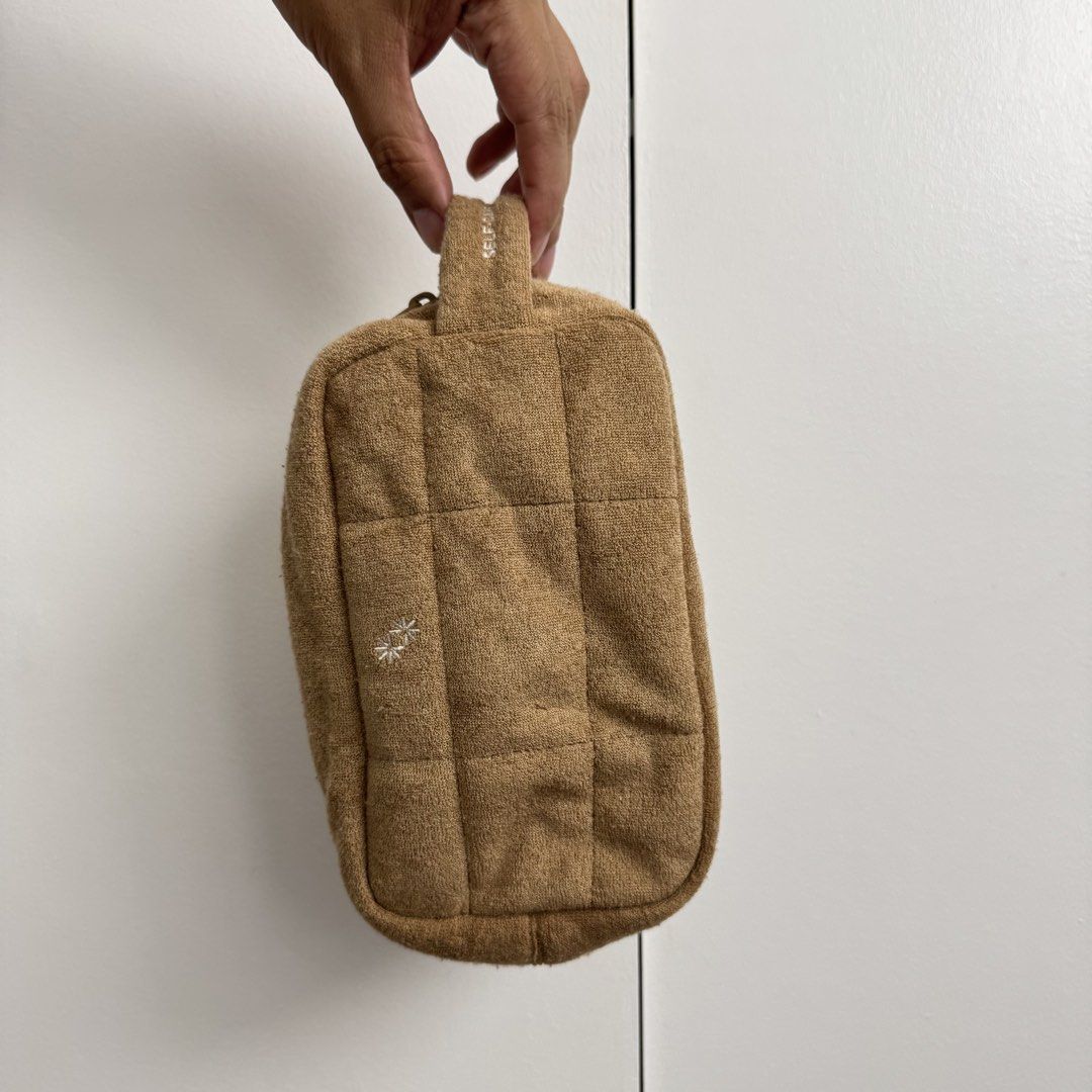 The Paper Bunny Cosmetic Bag (Category: Purses & Pouches) located in Pasig City. Submitted by cruelsummer69 (Listing ID 1431044732, Image 1). Description: Cosmetic bag from The Paper Bunny features a soft, textured exterior with a quilted design. It has a top handle and a zipper closure. The interior includes a small pocket. The bag is tan in color and has the words "SELF-CARE IS HEALTH CARE" printed on the side. The Paper Bunny logo is also visi
