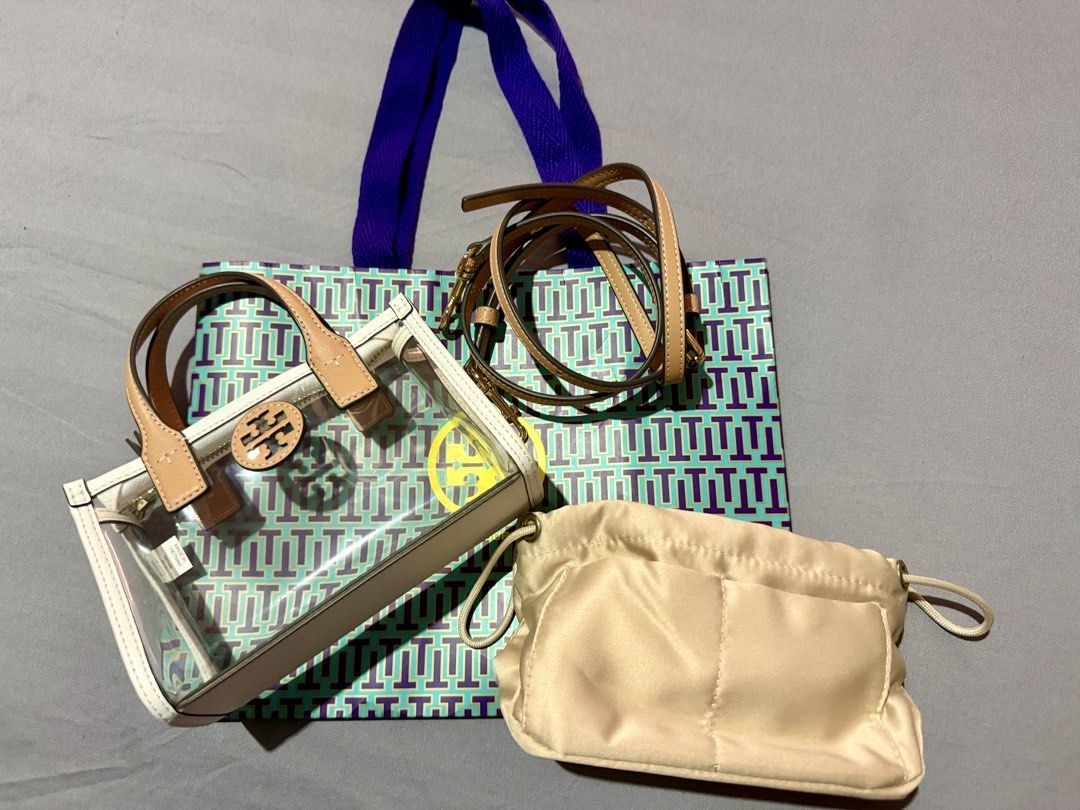 Tory Burch Mini Ella (Category: Luxury Bags & Wallets) located in Pasay City. Submitted by jennchua19 (Listing ID 1431035465, Image 1). Description: Description -Authentic Tory Burch Mini Ella -white and tan in color -Clear PVC Vinyl - gold Zip closure - adjustable removable cross body strap 23.1” - height 4.8”, length 7.2”, depth 2.8” -with FREE insert pouch (para ndi kita loob) bought from orange app 600 pesos only used once - ndi ko nagagamit 