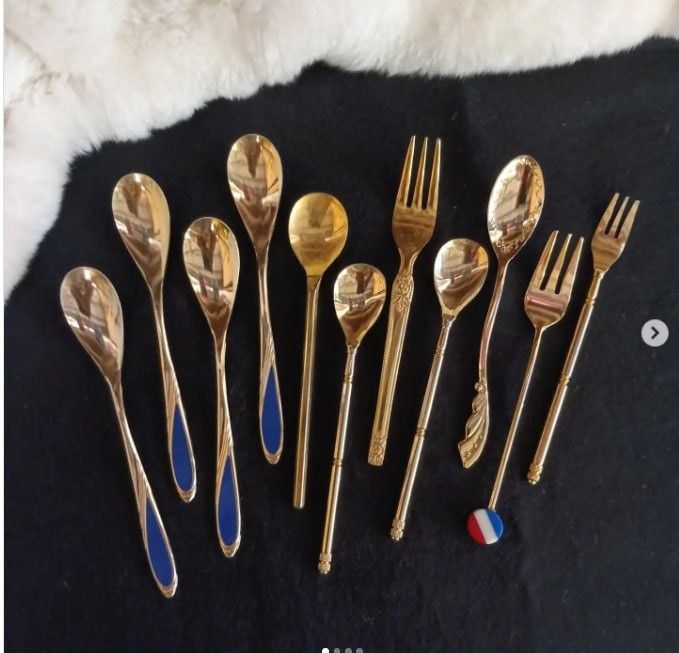 Vintage Gold Spoons and Forks Tea Set (Category: Dinnerware & Cutlery) located in Quezon City. Submitted by mrsincognito (Listing ID 1431178809, Image 1). Description: Elegant set of vintage gold spoons and forks. Includes various spoon sizes and forks with decorative handles. Some spoons have blue enamel detailing. Features a French flag charm. Perfect for adding a touch of vintage charm to your dining experience..
