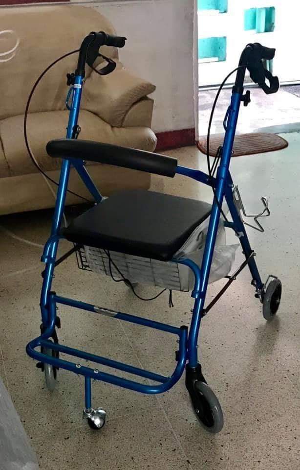 Walker with Seat (rollator) (Category: Medical Supplies & Tools) located in Quezon City. Submitted by brightphoenix.af3fd8 (Listing ID 1431054423, Image 1). Description: walker features a built-in seat and a basket for storage. It has four wheels for easy maneuverability, with two smaller wheels in the front and larger ones in the back. The walker also includes hand brakes for added safety..