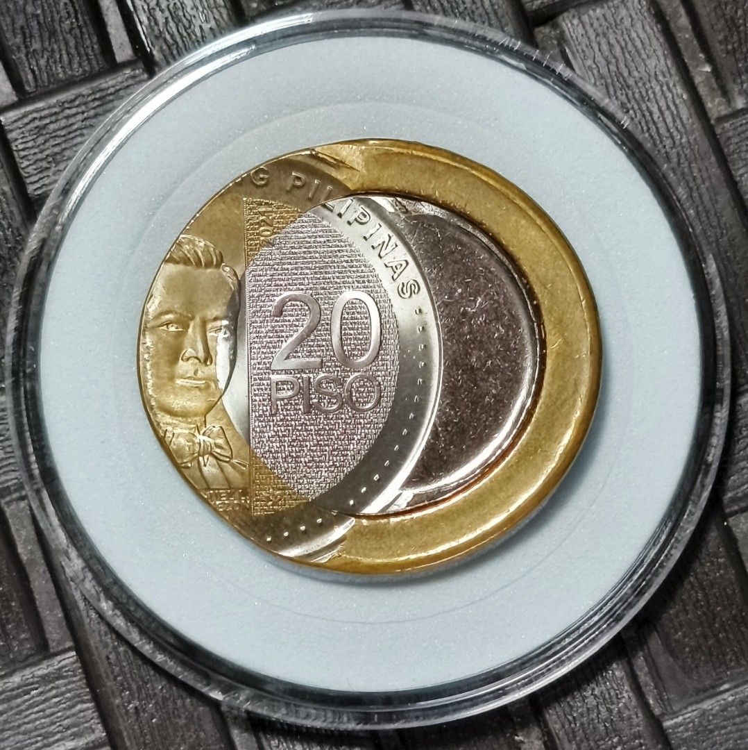 20 Piso Coin "off center error" (Category: Currency) located in Taguig. Submitted by ezekiel103 (Listing ID 1435493678, Image 1). Description: - 20 Piso Coin"off center error" - Encased in a clear protective case - Features a portrait on one side - Plant design on the other side - Gold-colored outer ring - Silver-colored middle section - Copper-colored center 30k nalang.