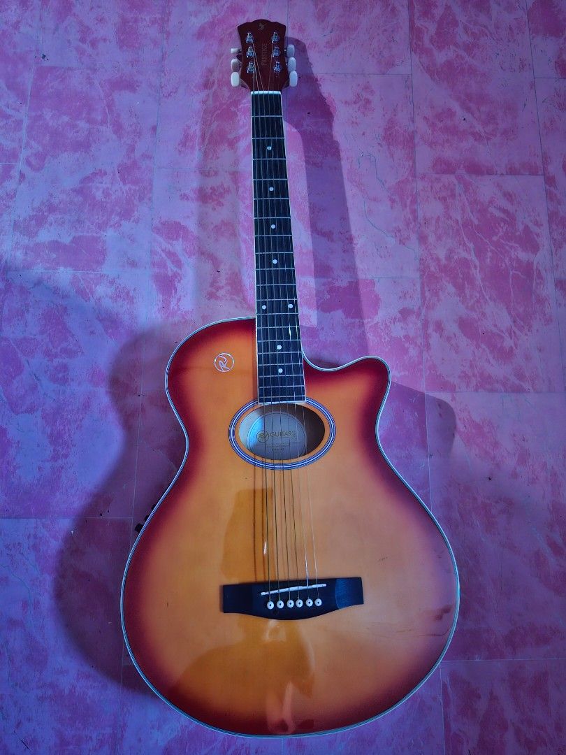 Acoustic-Electric Guitar with Case (Category: Musical Instruments) located in Manila. Submitted by grandgem-2085 (Listing ID 1435432689, Image 2). Description: -Bought 2023 Php 8000 -Good as new but with minimal scratch at the back - Acoustic-electric guitar with sunburst finish - Includes a black carrying bag - Comes with cable - Equipped with an onboard tuner for convenient tuning - Built-in preamp for amplified sound - Guitar has a logo on the