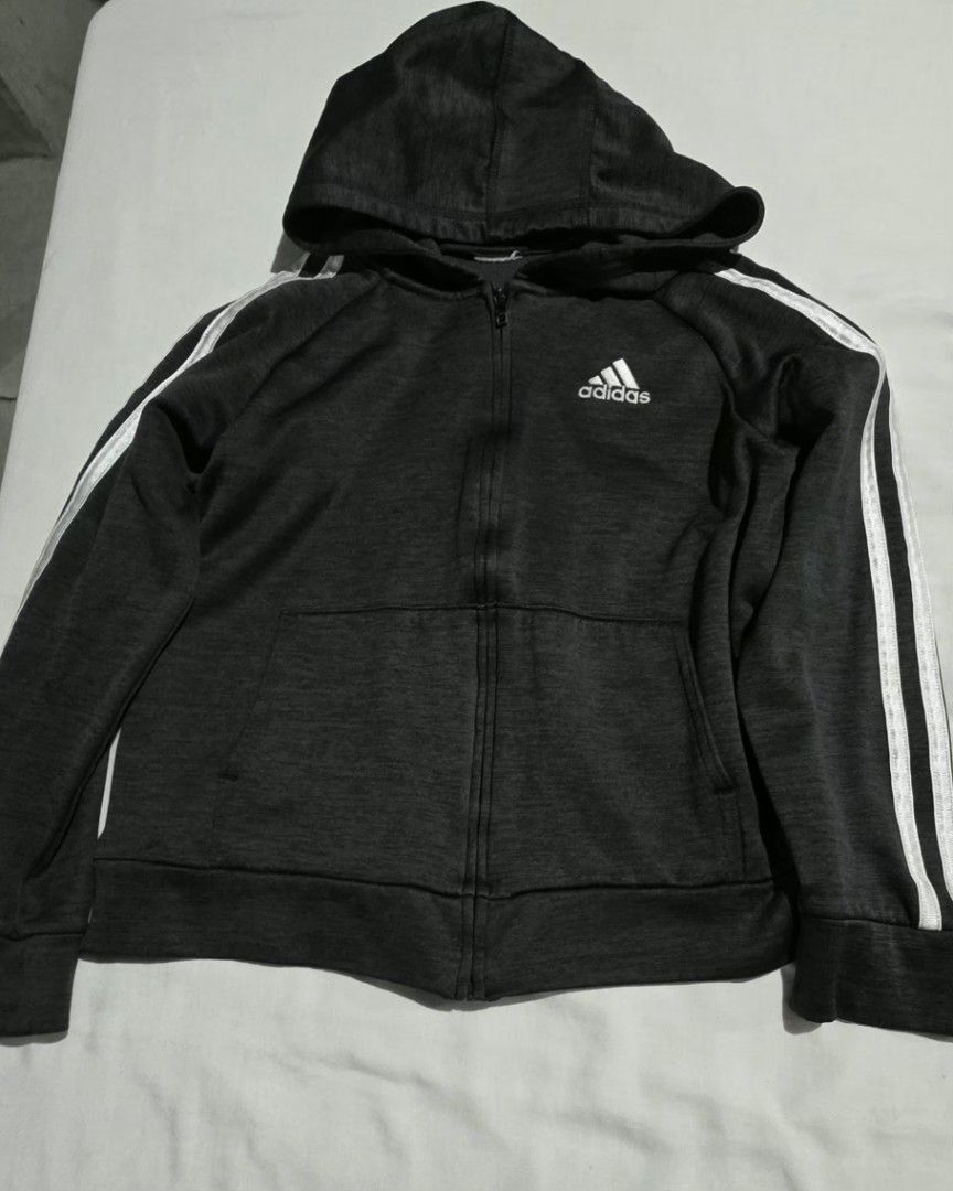 Adidas Hoodie with Stripes (Category: Hoodies) located in Pasig City. Submitted by budolresponsibly (Listing ID 1435446323, Image 1). Description: - Adidas full-zip hoodie - Dark grey color - Adidas logo on chest - Three white stripes on sleeves - Hooded - Two front pockets - Ribbed cuffs and hem - Comfortable for everyday wear -4/5T.