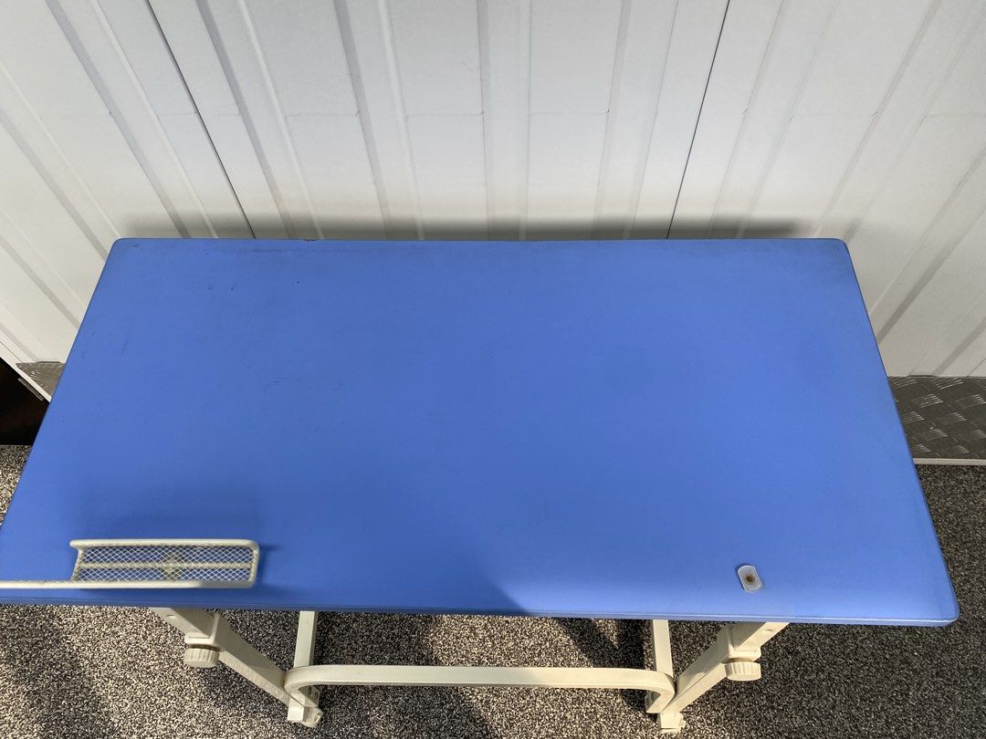Adjustable Table (Category: Tables & Sets) located in Singapore. Submitted by sandy_teo (Listing ID 1435362287, Image 2). Description: - Adjustable laptop table - Vibrant blue surface - Sturdy white frame - Includes wheels for easy movement - Small wire mesh holder - Height adjustable - Perfect for work or study.